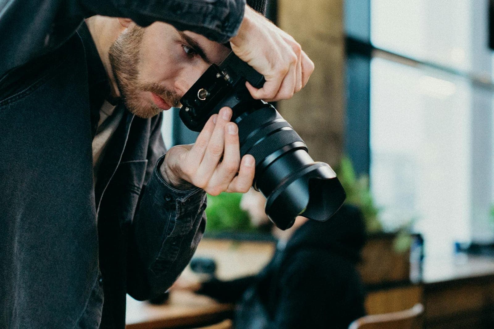Photographer shooting with a DSLR camera in a studio